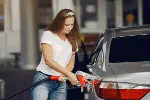 Woman filling her car with gas before heading to vehicle storage.