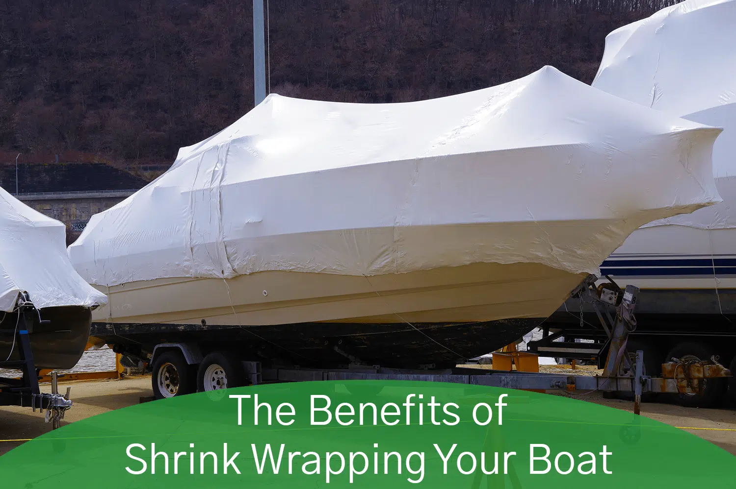 A boat with white shrink wrapping cover it from the elements.