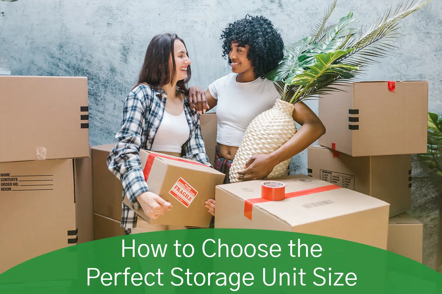 A white woman and a black woman surrounded by cardboard boxes, deciding what storage unit size they need.