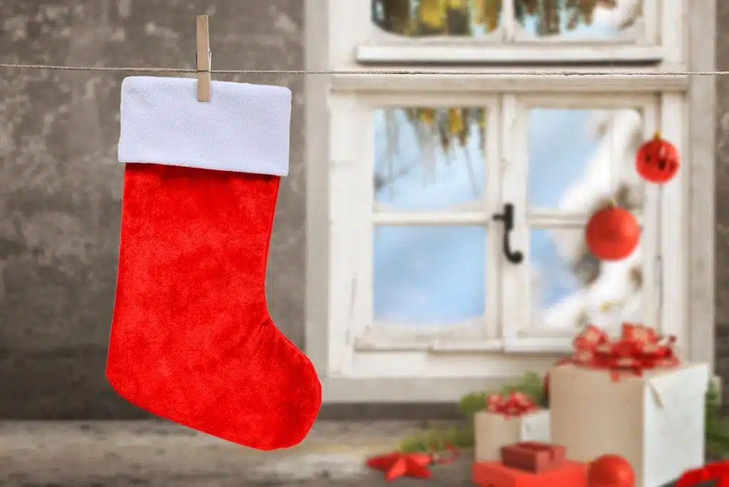 Empty Christmas stocking hanging on a rope with washer clip